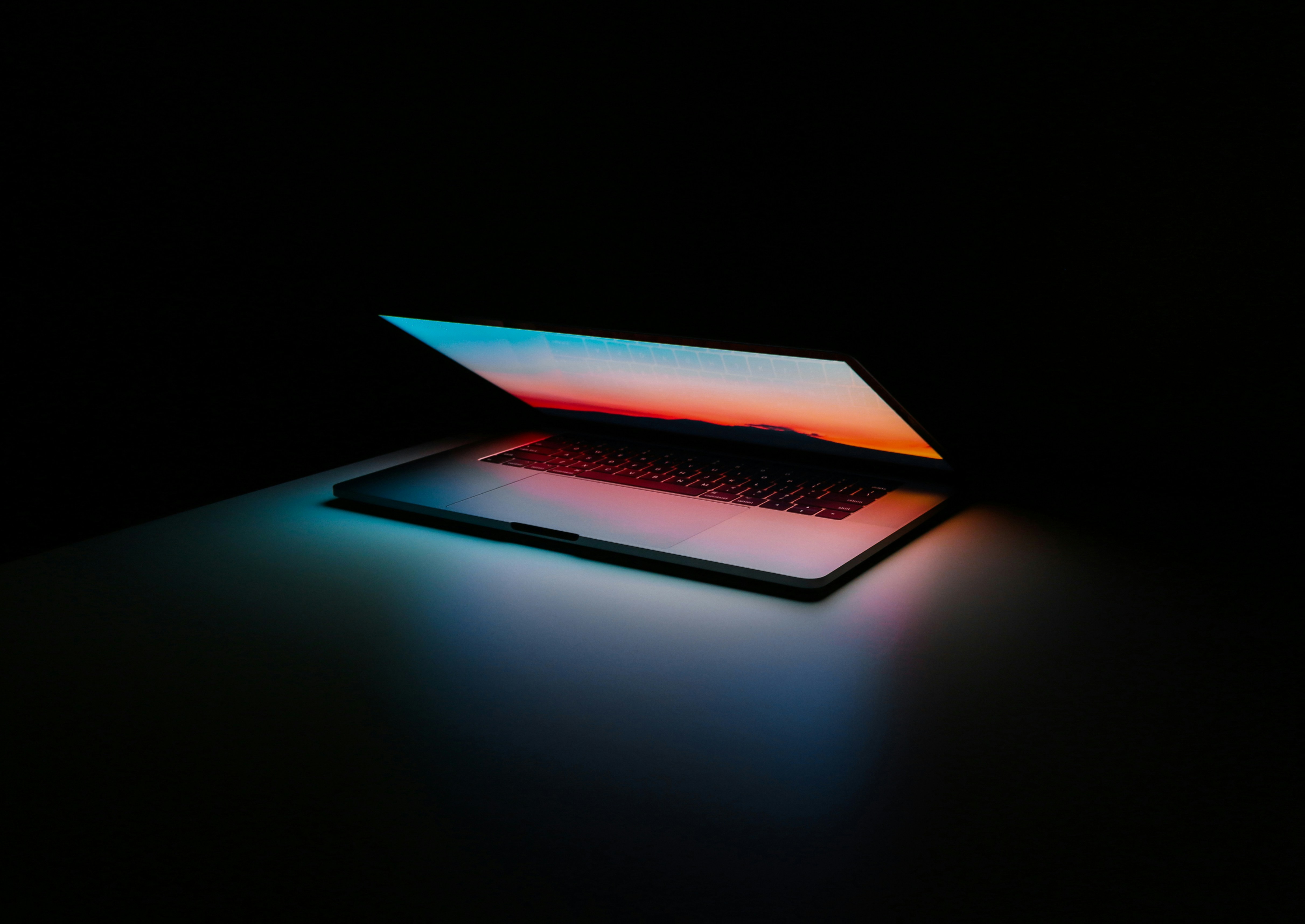 Laptop illuminated by blue and orange light